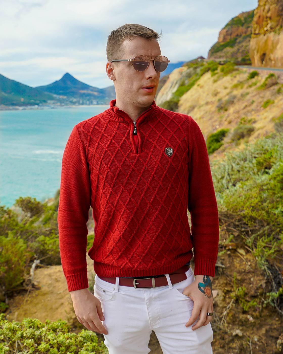 Mikhail in a red sweater on a coastal road